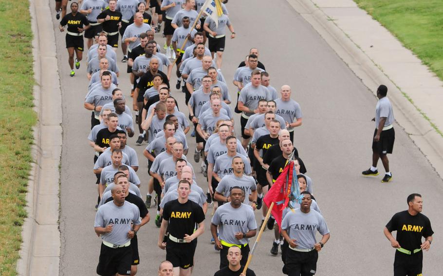 Soldiers with the 1st Infantry Division conduct a division run at Fort Riley, Kan., in June 2015. Currently, soldiers may wear either the gray Individual Physical Fitness Uniform or the black Army Physical Fitness Uniform, with a requirement that only the APFU be worn after 2016. Sgt. Maj. of the Army Dan Dailey has said he would support a move to give troops the option of wearing black socks with their APFU, and the issue has been a hot topic at town hall events with the SMA around the globe.