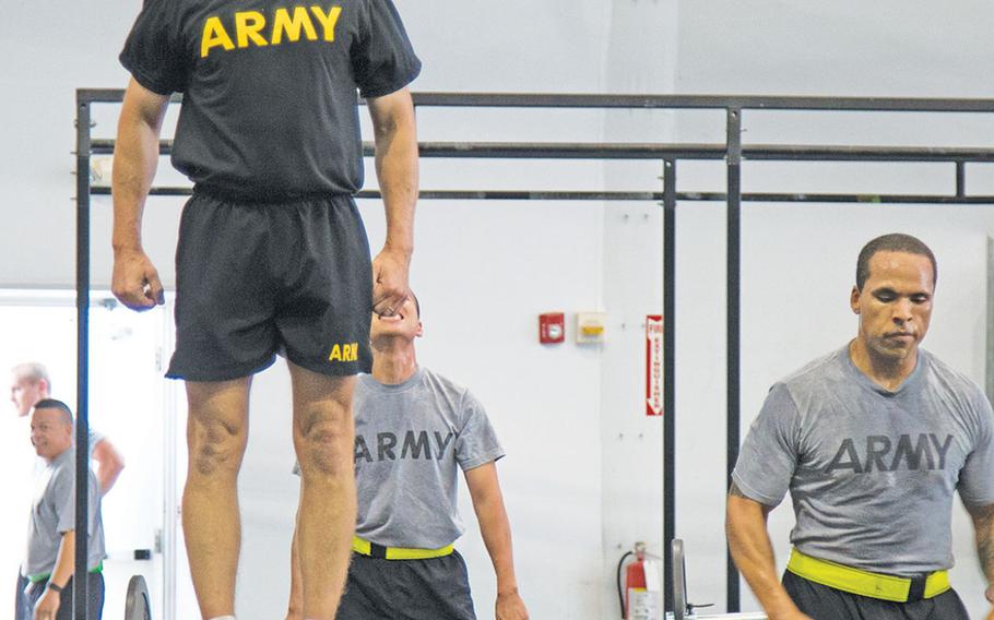 Sgt. Maj. of the Army Dan Dailey does physical fitness with soldiers at Fort Riley, Kan., during a visit there in early July 2015. With the transition to the new black Army Physical Fitness Uniform, which Dailey is wearing here, the SMA has said he supports giving troops the option of wearing black socks if surveys show most troops like the idea.