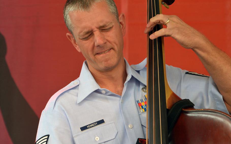 Bassist Tech. Sgt. Sam Kennedy of the USAFE Band's Wings of Dixie ensemble finds his groove during a song while playing at Swinging Lautern in downtown Kaiserslautern, Germany, Friday, Sept. 4, 2015.