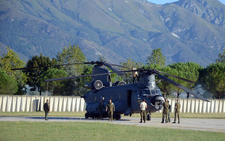 Dutch maintainers work on a Chinook helicopter at Aviano Air Base, Italy, before being taken on a training sortie through the mountainous terrain Tuesday, Sept. 8, 2015.