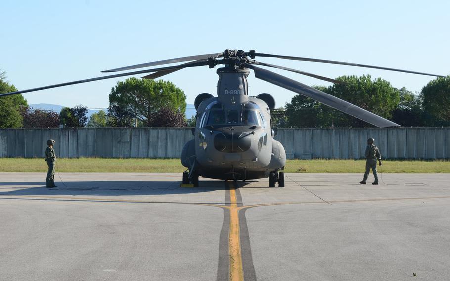 Dutch load planners and pilots prep a Chinook helicopter at Aviano Air Base, Italy, before flying a sortie Tuesday, Sept. 8, 2015.