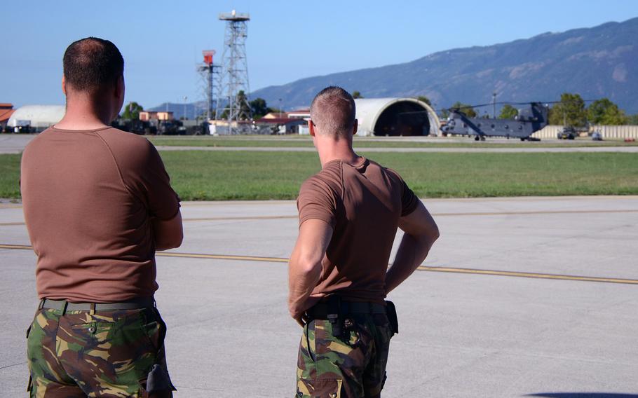 Dutch maintainers watch as a Chinook prepares to taxi down the runway at Aviano Air Base, Italy, on Tuesday, Sept. 8, 2015.