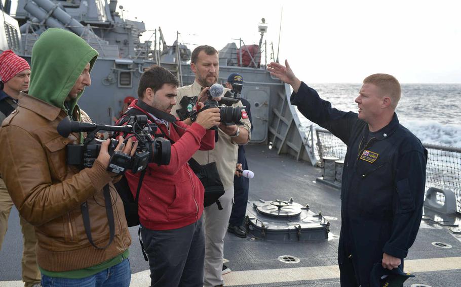 Cmdr. Peter Halversen, executive officer of the guided-missile destroyer USS Carney, speaks to media aboard the ship on Sept. 23, 2015. Halversen is wearing one of two flame-resistant coverall prototypes - the flight suit variant--being tested by Carney crewmembers for the Navy. 