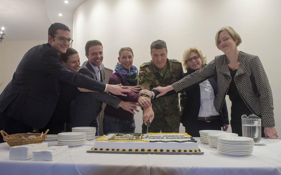 Representatives of EBS University of Business and Law and Frankfurt University of Applied Sciences cut a cake with German Brig. Gen. Markus Laubenthal, U.S. Army Europe chief of staff, during a ceremony Wednesday, Oct. 21, 2015, launching a local national student internship program sponsored by USAREUR.This is the first year for the program, which USAREUR says will place around seven students or recent graduates of German universities into intern positions.