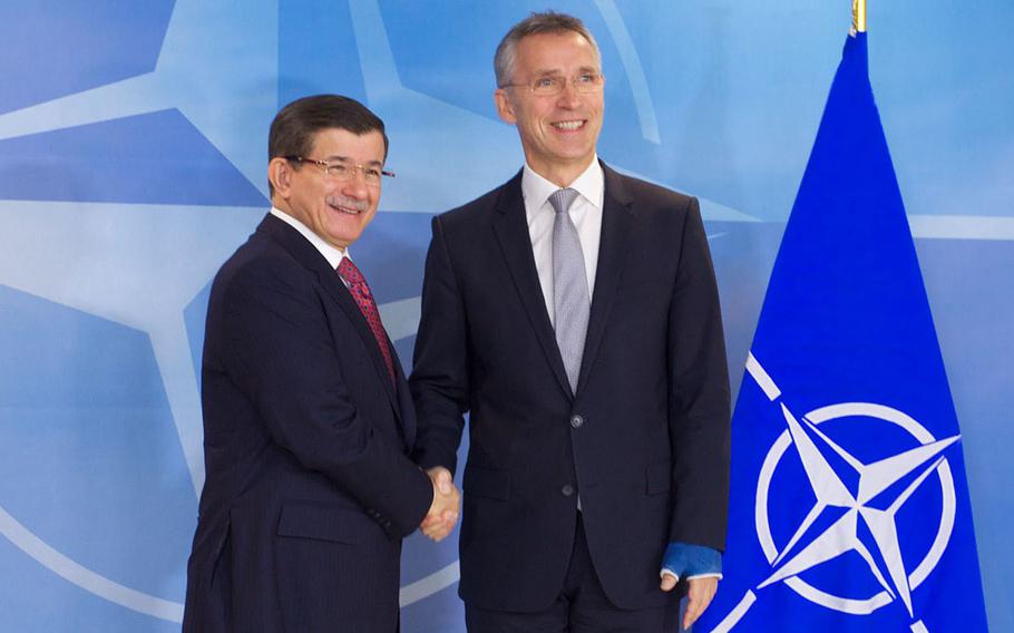NATO Secretary-General Jens Stoltenberg, right, meets with Turkish Prime Minister Ahmet Davutoglu at NATO headquarters in Brussels, Monday, Nov. 30, 2015.