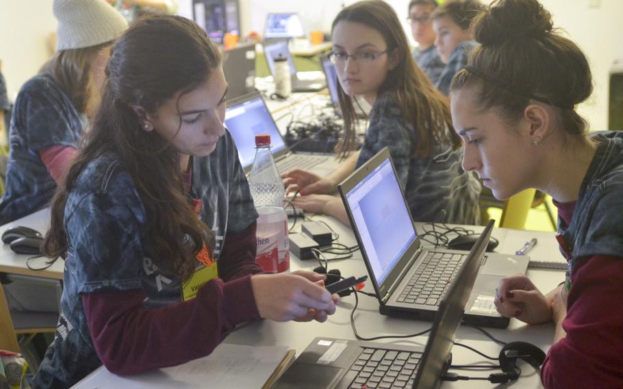 Valerie Gilfoy, left, of Naples High School, and Morgan Cotner, right, of Wiesbaden High School, examine a piece of equipment during a computer simulations engineering seminar on Monday, Dec. 7, 2015, at the DODDS-Europe STEMposium, an annual event bringing together some of the brightest minds in the school system for a week of innovation and intellectual development.