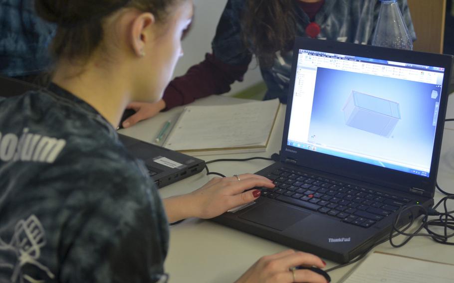 Morgan Cotner of Wiesbaden High School uses modeling software during a computer simulations engineering seminar on Monday,  Dec. 7, 2015, at the DODDS-Europe STEMposium, an annual event bringing together some of the brightest minds in the school system for a week of innovation and intellectual development. Computer simulations engineering students were challenged with designing and building - with a 3D printer - a plastic clip to attach to cellular phones.