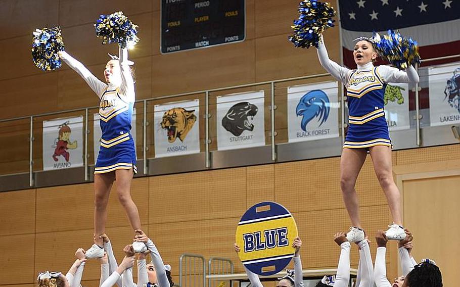 Two members of the Sigonella cheer squad perform while being held up by their teammates during the 2017 DODEA-Europe cheerleading competition on Saturday, Feb. 25, 2017, in Wiesbaden, Germany. Sigonella took first place in the Division III category.