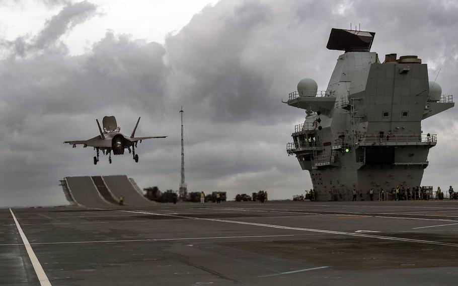 A U.S. F-35 fighter hovers over the HMS Queen Elizabeth on Nov. 3, 2018, during integration trials aboard the carrier.