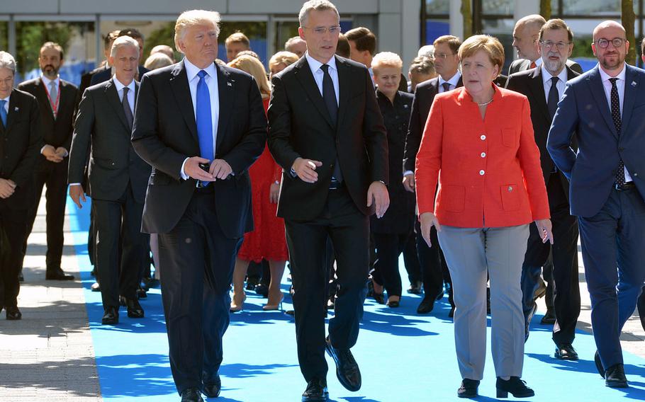 President Donald Trump, NATO Secretary-General Jens Stoltenberg and German Chancellor Angela Merkel walk with other leaders during a NATO meeting in Brussels, Belgium, May 25, 2017. Observers say a chief concern as NATO turns 70 is that the source of tension is mainly coming from the alliance's two most important member states: the U.S. and Germany.