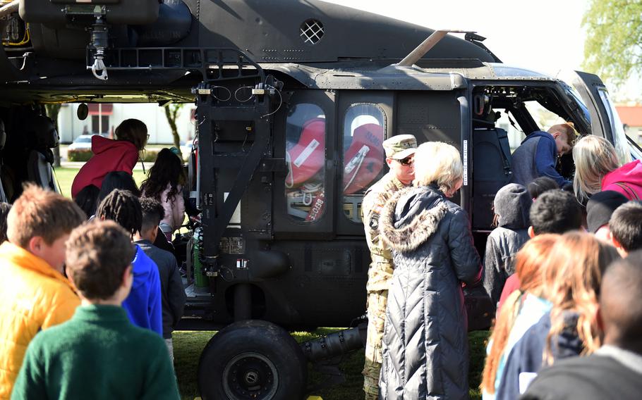 Students from the Grafenwoehr Elementary School climb inside a UH-60 Black Hawk helicopter during a Science Technology Engineering and Math activity on base, at Grafenwoehr, Germany, Tuesday, April 30, 2019.