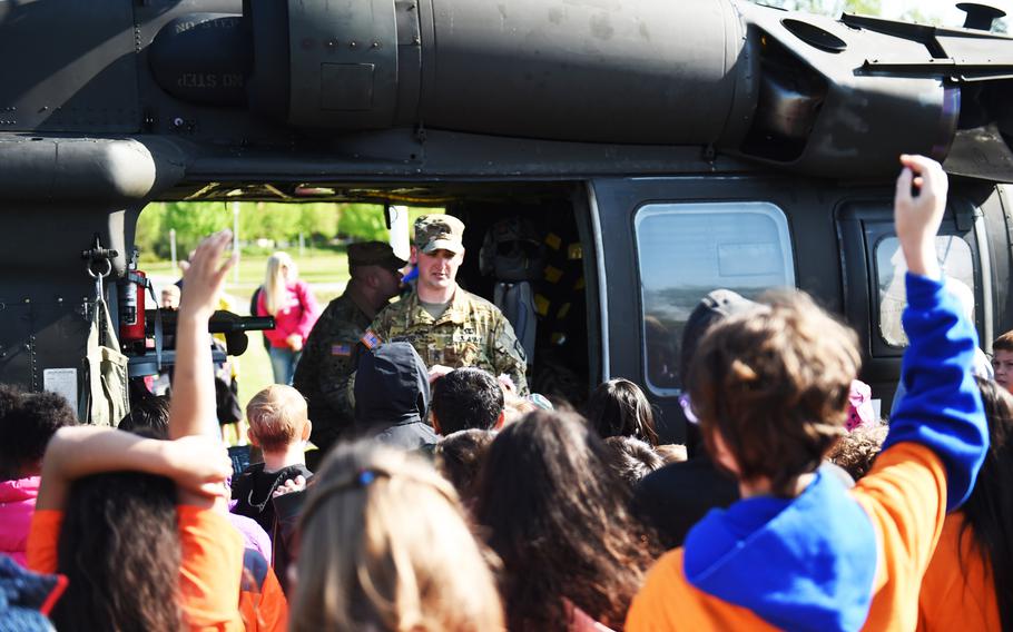 Students from the Grafenwoehr Elementary School ask questions about a UH-60 Black Hawk helicopter during a Science Technology Engineering and Math activity on base, at Grafenwoehr, Germany, Tuesday, April 30, 2019.