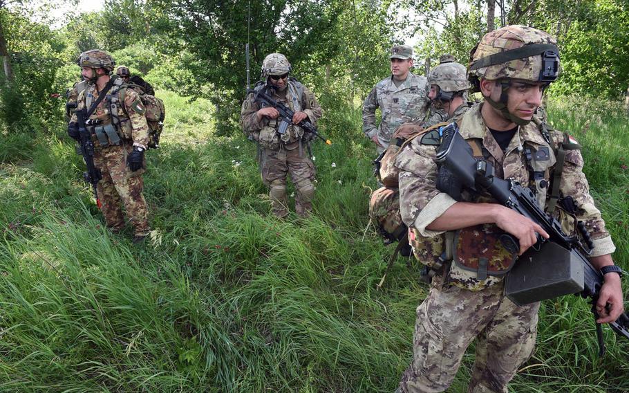 Italian paratroopers and U.S. soldiers waiting on their next orders, during Exercise Swift Response, in Bobocu, Romania, Friday, June 14, 2019.