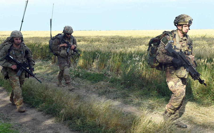 U.S. and Italian paratroopers on patrol during Exercise Swift Response, in Bobocu, Romania, Friday, June 14, 2019.
