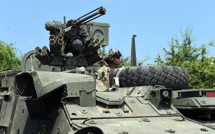 Sgt. Jashua Garcia, a Stryker gunner with the Army's 2nd Cavalry Regiment, looks out over his vehicle in a defensive position, during Exercise Saber Guardian in Cincu, Romania, Monday, June 17, 2019.