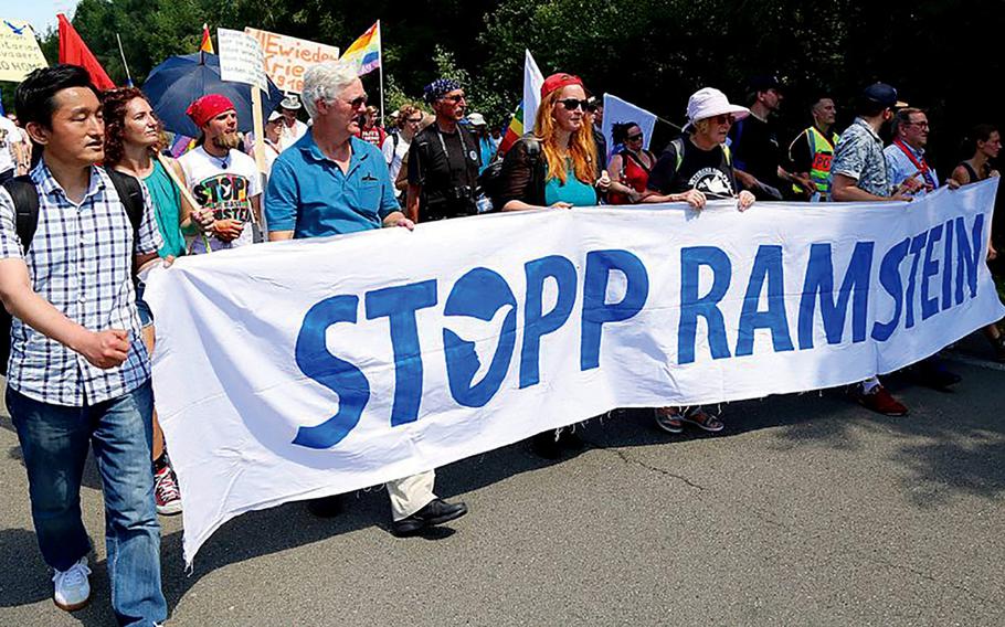 Protesters march outside Ramstein Air Base, Germany, on June 30, 2018. Several thousand protestors are expected to demonstrate again this weekend, calling for the end of drone warfare and the closure of Ramstein Air Base.