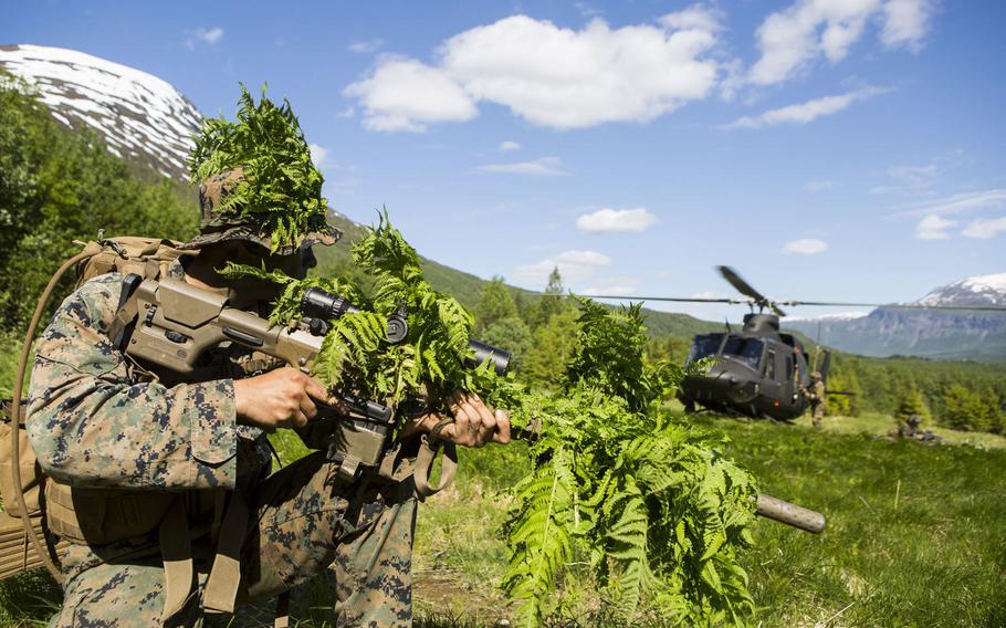 A U.S. Marine scout sniper with Marine Rotational Force-Europe 19.2, Marine Forces Europe and Africa, secures a landing zone for a Norwegian Army UH-1 during exercise Valhalla in Setermoen, Norway, June 17, 2019.