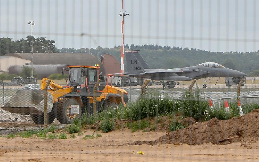 An F-15E Strike Eagle taxis by construction for F-35 Lightning II aircraft facilities on RAF Lakenheath, Monday, July 15, 2019. The first F-35 Lightning II are scheduled to arrive in November 2021.