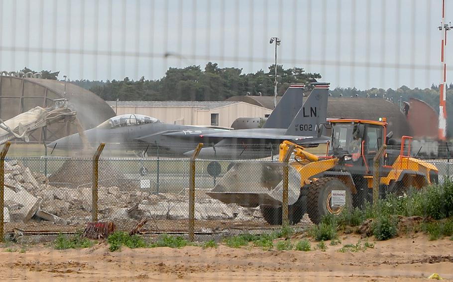 An F-15E Strike Eagle taxis by construction for F-35 Lightning II aircraft facilities on RAF Lakenheath, Monday, July 15, 2019. The first F-35 Lightning II are scheduled to arrive in November 2021.
