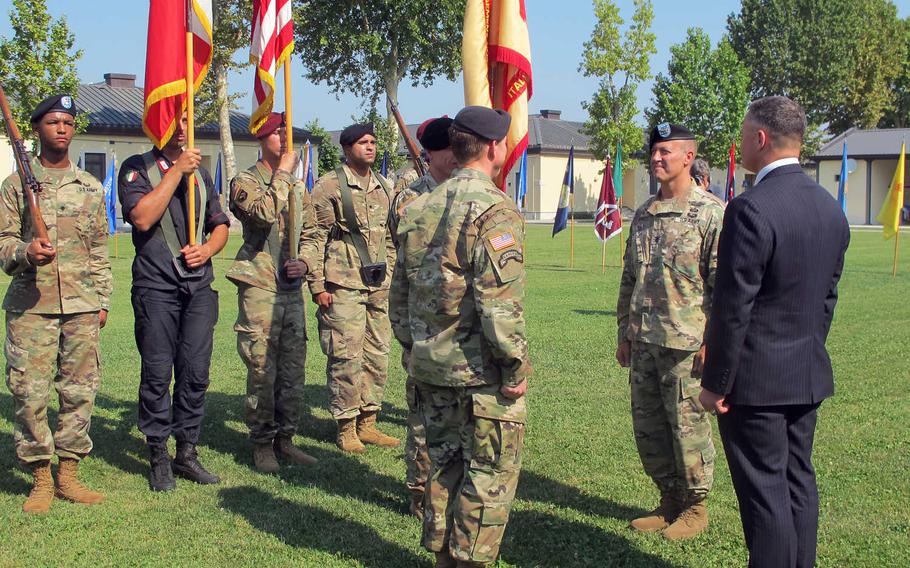 Col. Daniel Vogel takes command of U.S. Army Garrison Italy from Col. Erik Berdy, second from right, at a ceremony at Caserma Ederle in Vicenza, Italy, on Wednesday, July 24, 2019.