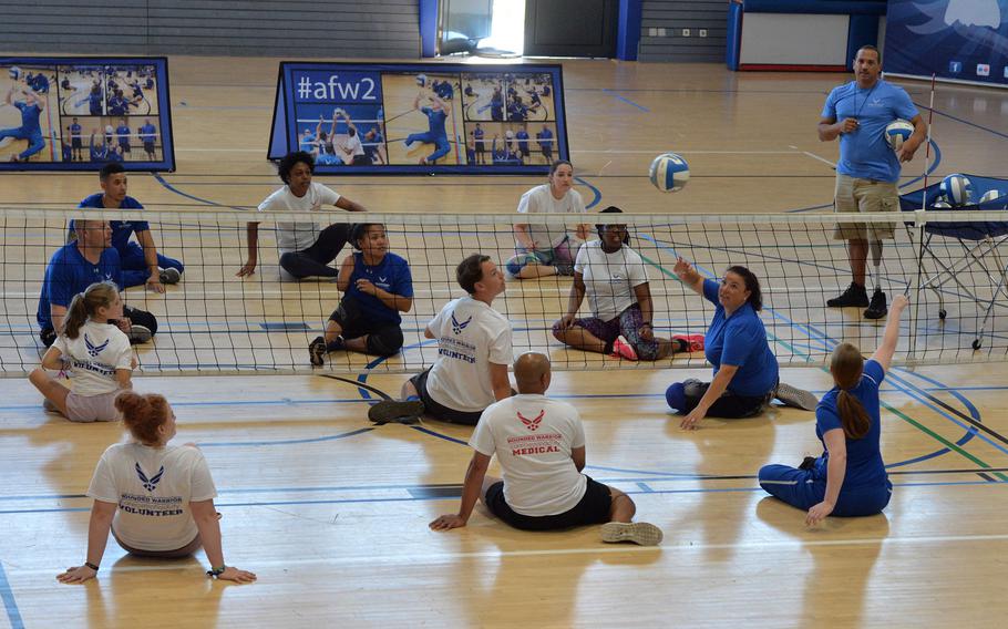 Senior Master Sgt. Brian Williams (right) referees wounded warriors, volunteers and medical staff during a game of seated volleyball for the Warrior Care event at Ramstein Air Base, Germany. The event, which is part of the Air Force Wounded Warrior program, is the first of its kind at an Air Force base in Europe. 