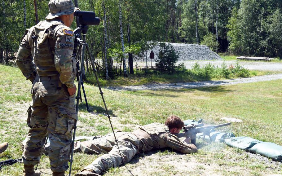 Sgt. Leon Boudreaux, left, spots a target while Spc. Maxwell Kelley fires during one of the events at the 2019 European Best Sniper Team Competition, at Grafenwoehr, Germany, Thursday, July 25, 2019.