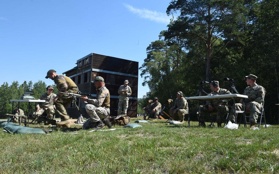 Latvian soldiers get into position to engage targets during one of the events at the 2019 European Best Sniper Team Competition, at Grafenwoehr, Germany, Thursday, July 25, 2019.