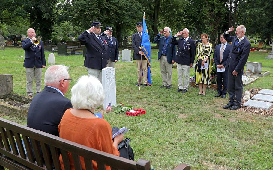Christopher Shea, left, plays taps on a Civil War bugle while the rest of the Ensign John Davis Camp 10 Sons of Union Veterans of the Civil War salute the gravestone in London of Maj. Seth Watson Herrick, Saturday, July 27, 2019.  Robert Herrick, seated, great-grandson of Maj. Herrick, traveled from California with his wife to attend the ceremony at Hendon Cemetery in north London. 