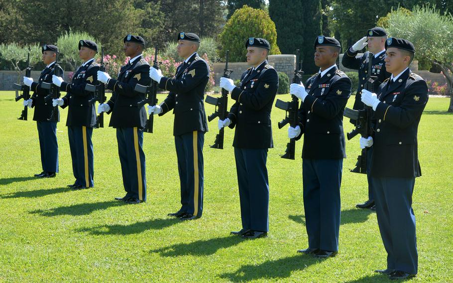 The firing detail from the U.S. Army's 1st Inland Cargo Transfer Company, Kaiserslautern, Germany, stand at attention during the playing of national anthems at the ceremony marking the 75th anniversary of Operation Dragoon at Rhone American Cemetery in Draguignan, France, Friday, Aug. 16, 2019.