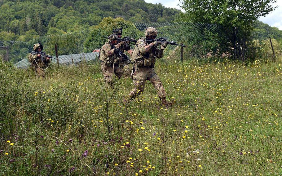 Soldiers with 1st Infantry Division's 1st Armored Brigade Combat Team, advance towards mock enemy forces during exercise Combined Resolve at Hohenfels, Germany, Monday, Aug. 19, 2019.