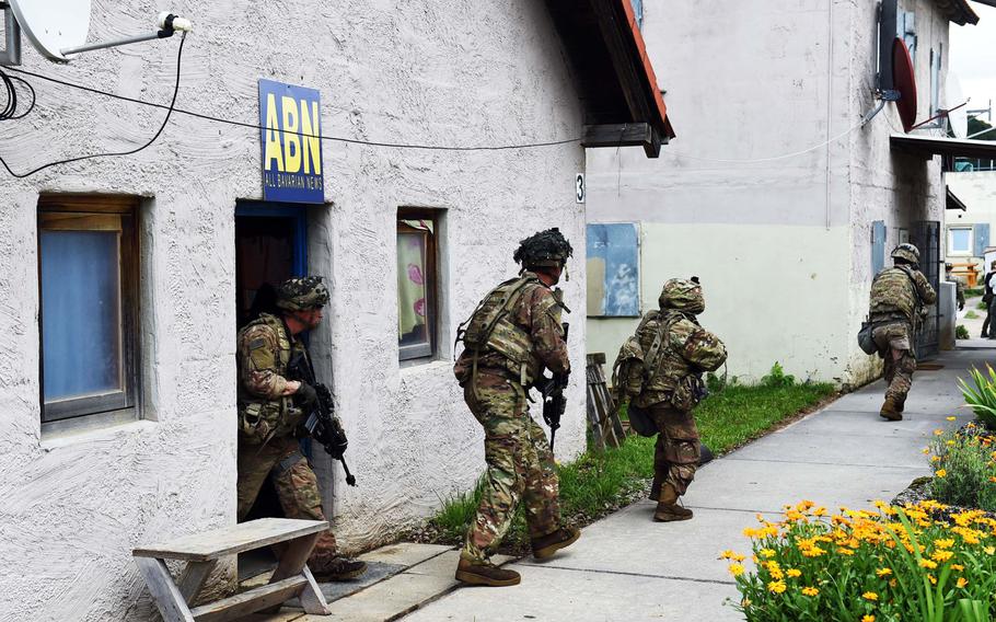 Soldiers with the 1st Infantry Division's 1st Armored Brigade Combat Team exit a building to engage "enemy forces" during exercise Combined Resolve at Hohenfels, Germany, Monday, Aug. 19, 2019.