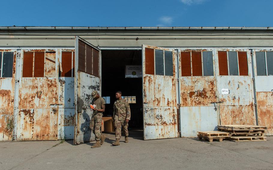 Soldiers walk out of the supply support activity on a military base in Powidz, Poland, Aug. 27, 2019.