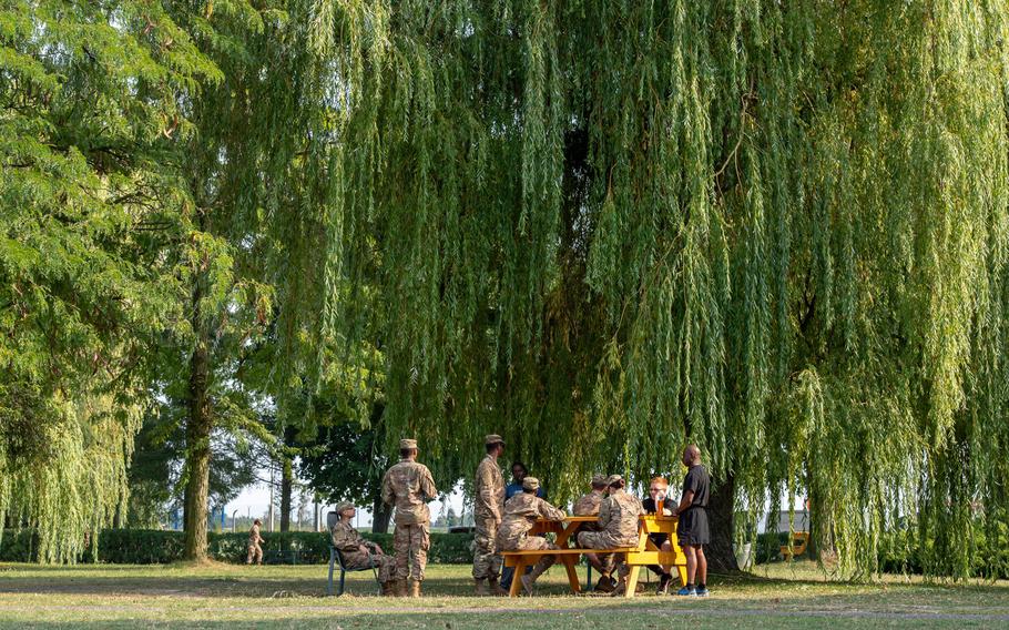 Rotational soldiers gather at a park bench on a military base in Powidz, Poland, Aug. 27, 2019. Deployments to the base generally last up to nine months.