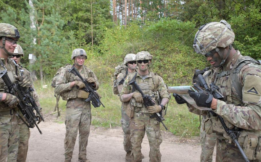 A squad of U.S. soldiers from 1st Battalion, 4th Infantry, 7th Army Training Command, locates their next event after performing in the grenade range event at the Lithuanian Land Forces Best Infantry Squad Competition, Aug. 28, 2019, in Rukla, Lithuania.