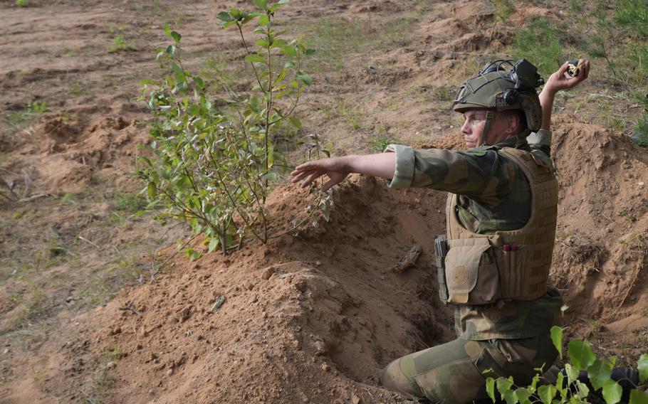 A Norwegian soldier throws a fake grenade at the Best Infantry Squad Competition, Aug. 28, 2019, in Rukla, Lithuania.