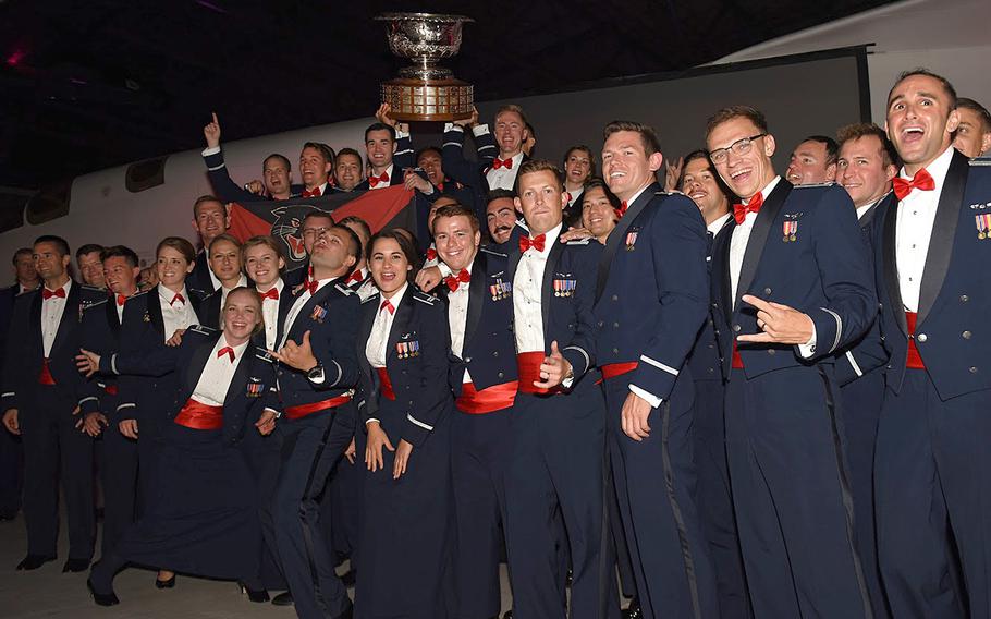 Airmen from the 494th Fighter Squadron pose with the Raytheon Trophy at Duxford Imperial War Museum, England, Aug. 31, 2019 after receiving the award in recognition of the squadron's overall performance and its Middle East deployment last year.