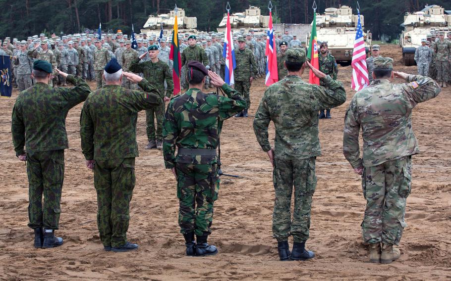 Multinational troops salute during Saber Strike 17 at Pabrade, Lithuania, June 2017. The U.S. needs to share more intelligence about Russian activities with allies and spend more time explaining the threat posed by Moscow, according to a think tank report.
