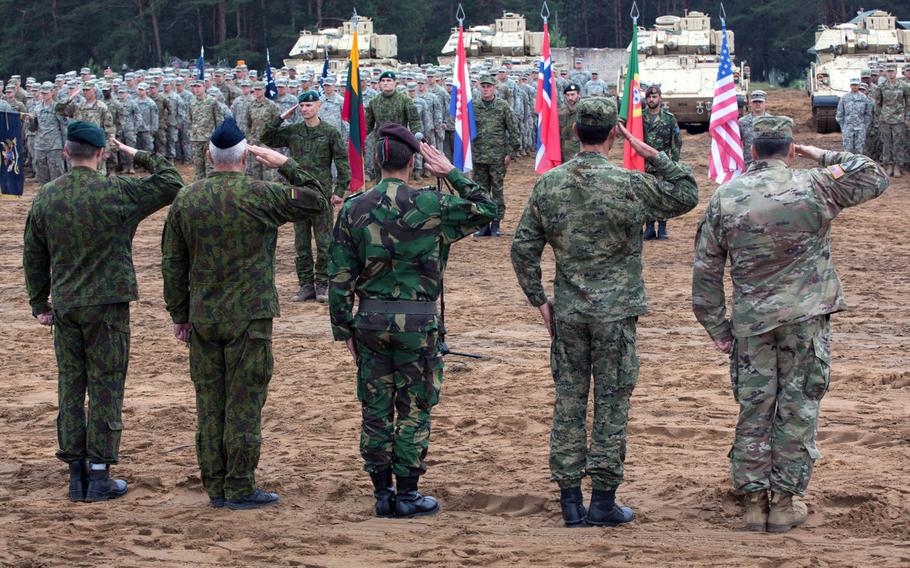 Multinational troops salute during Saber Strike 17 at Pabrade, Lithuania, June 2017.  The U.S. needs to share more intelligence about Russian activities with allies and spend more time explaining the threat posed by Moscow, according to a think tank report.