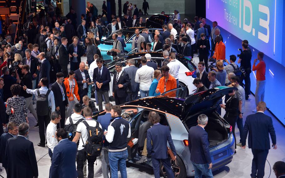 Visitors flock around VW's electric ID.3 car after it was unveiled at the IAA in Frankfurt. It is scheduled to go into production and be available next year at a price in Europe of around 30,000 euros ($33,200).