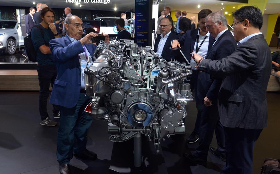 Visitors to the IAA in Frankfurt check out the four-cylinder diesel plug-in hybrid engine that powers the Mercedes-Benz GLE 350 car. The diesel is a 195-horsepower engine, while the electric motor puts out 136 horsepower.