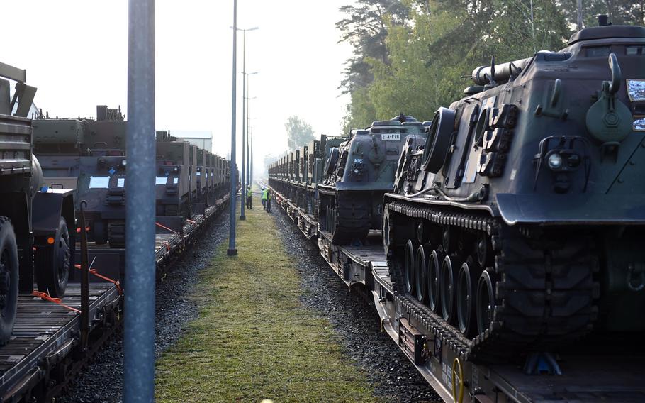 Rows of M270-A1 MLRS rocket launch systems and other vehicles arriving on train tracks in Grafenwoehr, Germany, Wednesday, Sept. 11, 2019.