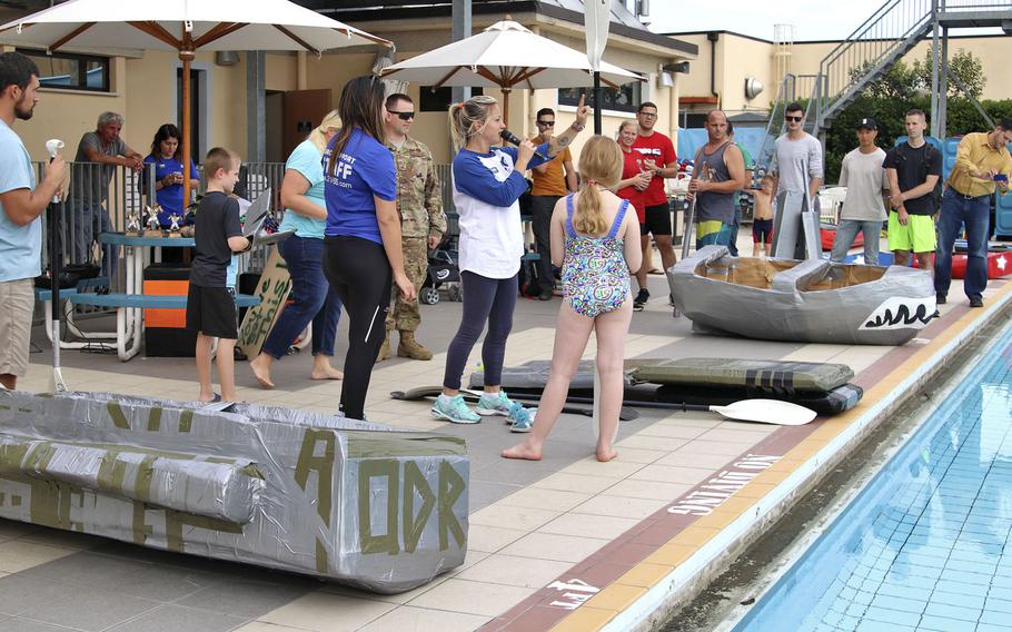 Competitiors receive final instructions before the start of the cardboard boat race at Aviano Air Base on Sept. 19, 2019. Four teams participated in the event, the first of its kind at Aviano.