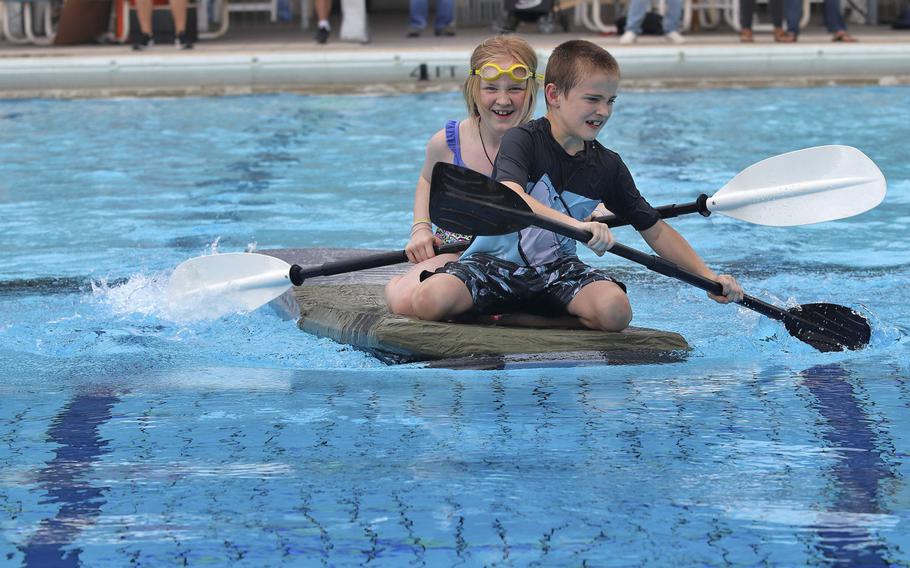 Drake and Teal Nash maneuver their vessel during the first-ever cardboard boat race to be held at Aviano Air Base on Sept. 19, 2019. Drake, 9, and Teal, 11, finished the race in second place.