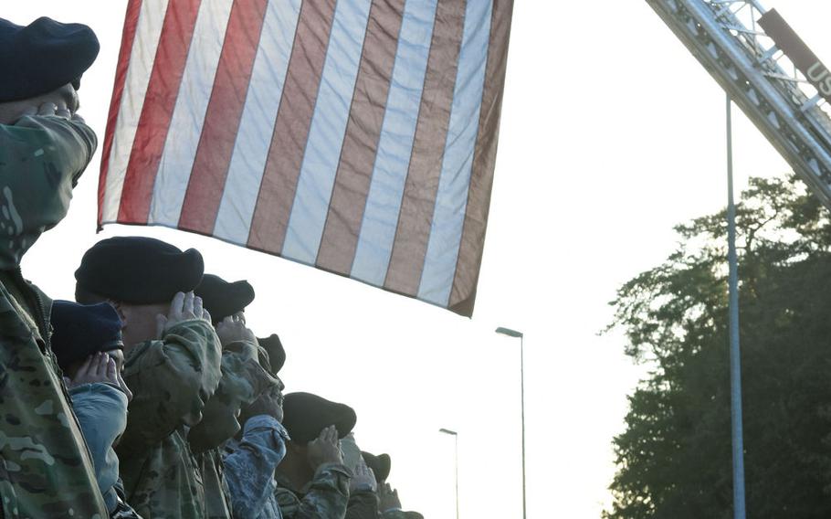 Personnel at Ramstein Air Base, Germany, render a final salute to military working dogs Sky and Diesel Friday, Sept. 20, 2019, as they are transported off base. Diagnosed with terminal cancer, the dogs were to be euthanized.