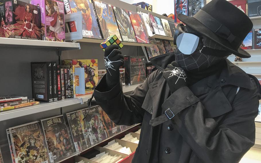 Vic Malone,18, is seen at X-Comics in the Kaiserslautern Military Community Center pondering the many colors of a Rubik's Cube while dressed as Spider-Man Noir for the KMCC Comic Con on Sunday, Sept.22, 2019. Malone cobbled together the costume from store-bought and homemade items, he said.