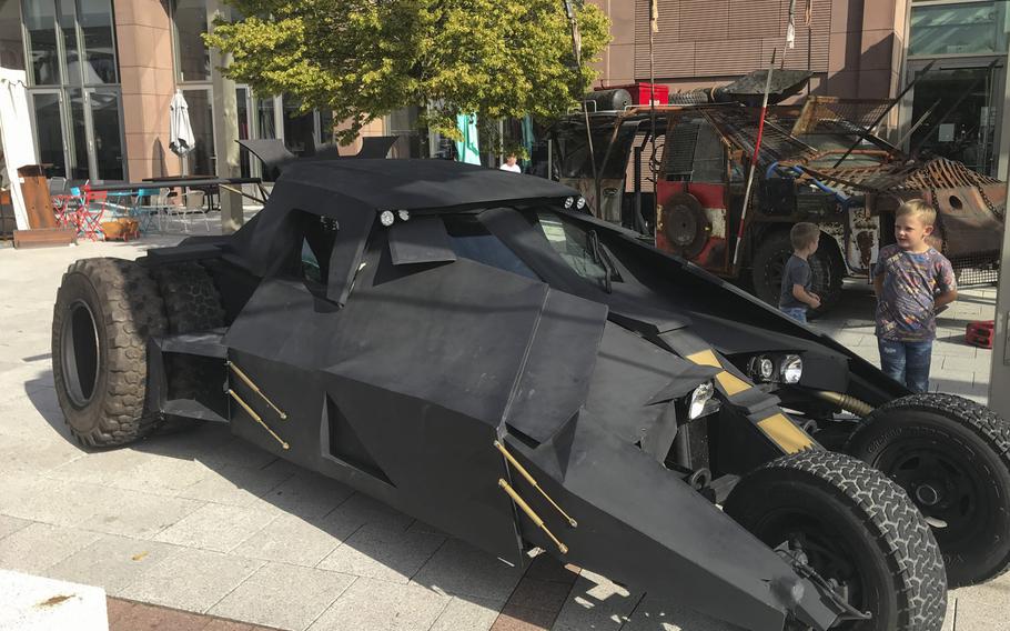 Children check out Air Force veteran Brian Sachs's movie-inspired autos on display at the Ramstein main exchange on Sunday, Sept.22, 2019, duirng the KMCC Comic Con event.