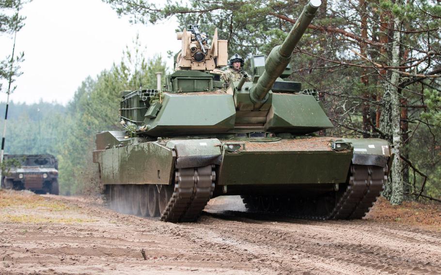 An M1A2 main battle tank belonging to 1st Armor Brigade Combat Team, 3rd Infantry Division drives through a training area in Pabrade, Lithuania, in 2015. More than 500 U.S. soldiers, along with their tanks and heavy fighting vehicles, will deploy to Lithuania on an extended mission to bulk up NATO?s eastern flank, Lithuanian military officials said in September 2019.