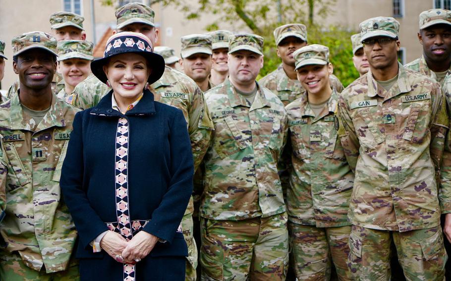 U.S. Ambassador to Poland Georgette Mosbacher poses with soldiers at a ceremony in Poznan, Poland, marking the change of name of the U.S. Army's headquarters in the country, Friday, Oct. 4, 2019. The unit is now called 1st Infantry Division (Forward).