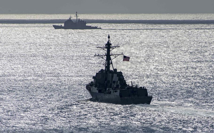The guided-missile destroyer USS Forrest Sherman, front, and the guided-missile cruiser USS Normandy transit the Atlantic Ocean, Sept. 16, 2019. The ships were operating in the Atlantic as part of a Surface Action Group in support of naval operations to maintain maritime stability and security.