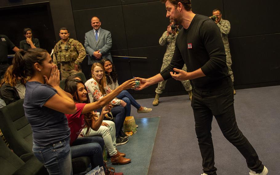 John Krasinski, star of the Amazon series ''Jack Ryan,'' is given a teapot, a reference to his former show ''The Office,'' by an audience member before a premiere of season two at the Ramstein Air Base theater, Germany, Oct. 15, 2019.